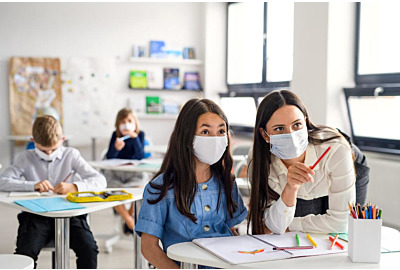Lehrer und Kinder mit Gesichtsmaske zurück in der Schule